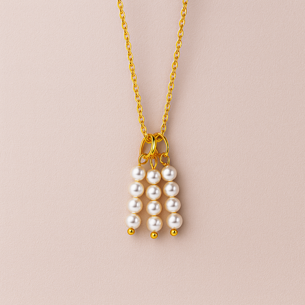 Charm de racimo de perlas blancas con detalles dorados en cadena dorada